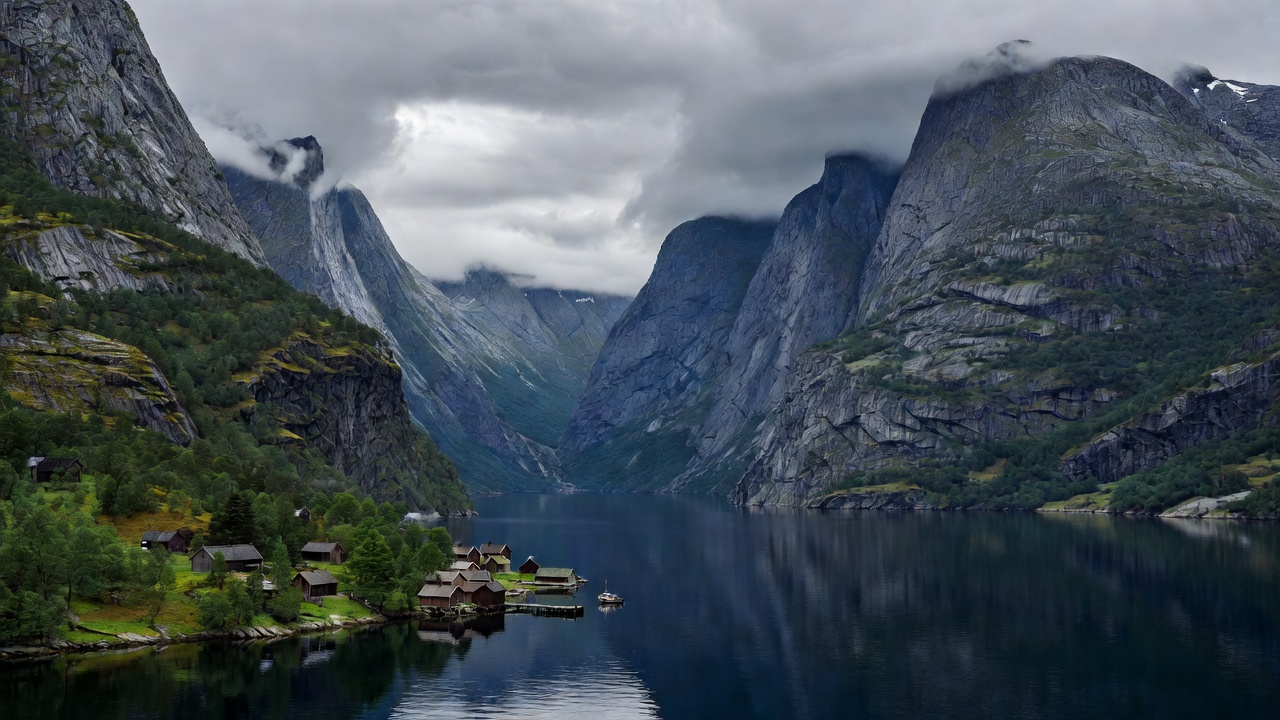 Steep mountains rising above the narrow waters and settled shore of Nærøyfjord in Norway